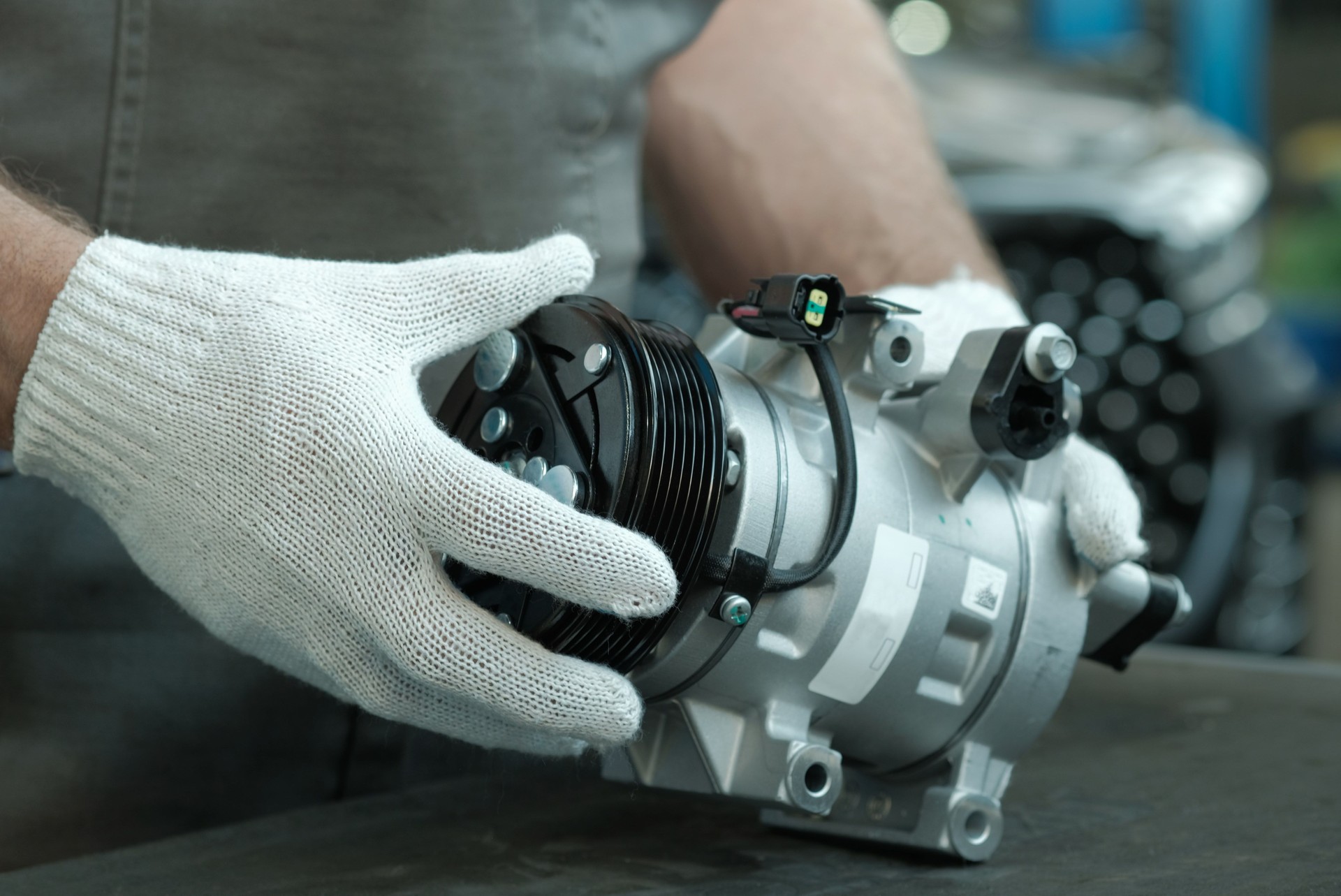 Car service. A new compressor for the air conditioner. Close-up.