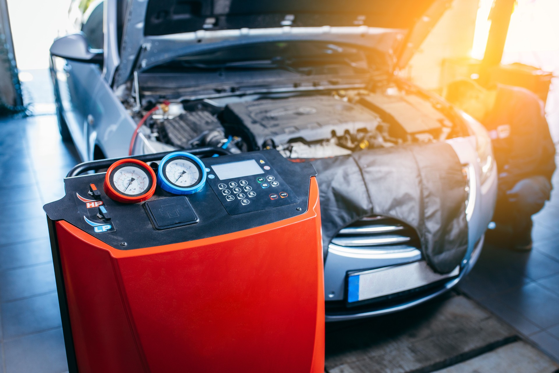 Working of servicing car air conditioner in vehicle auto service or repair workshop